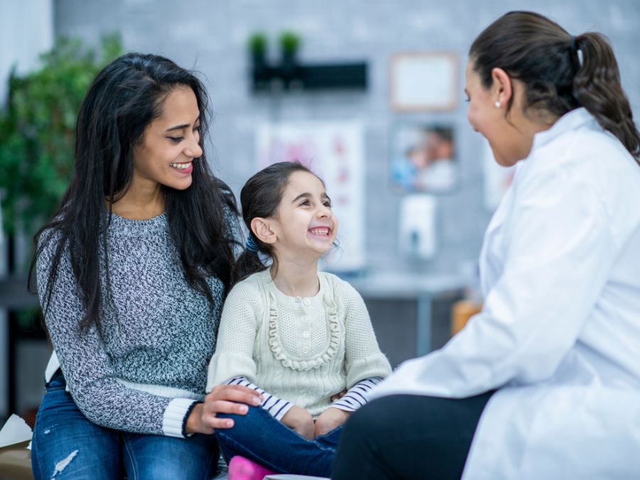 Parent and child visiting with a doctor.