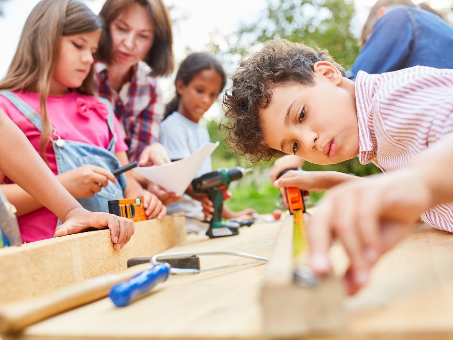 Children working with tools outside