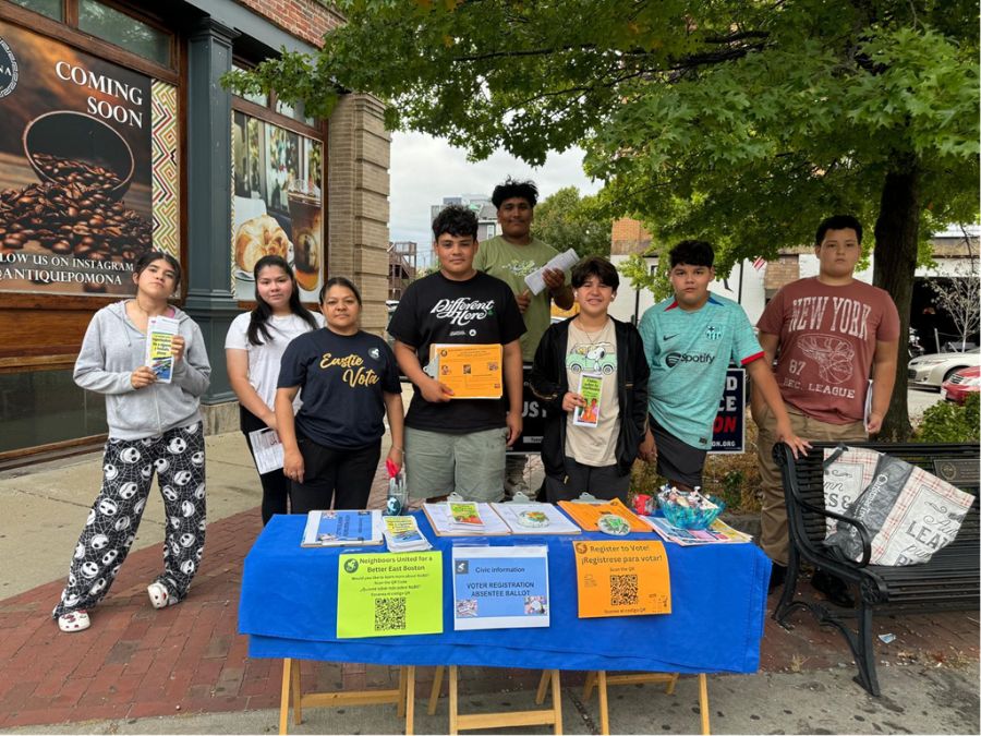 Teen volunteers standing at a table.