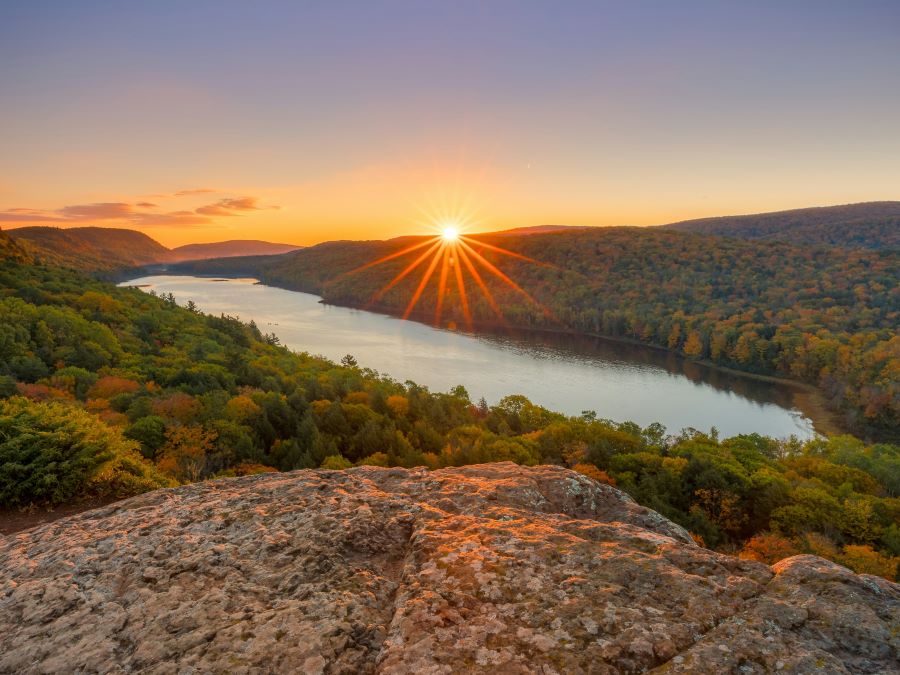 Sunrise over a forest and lake