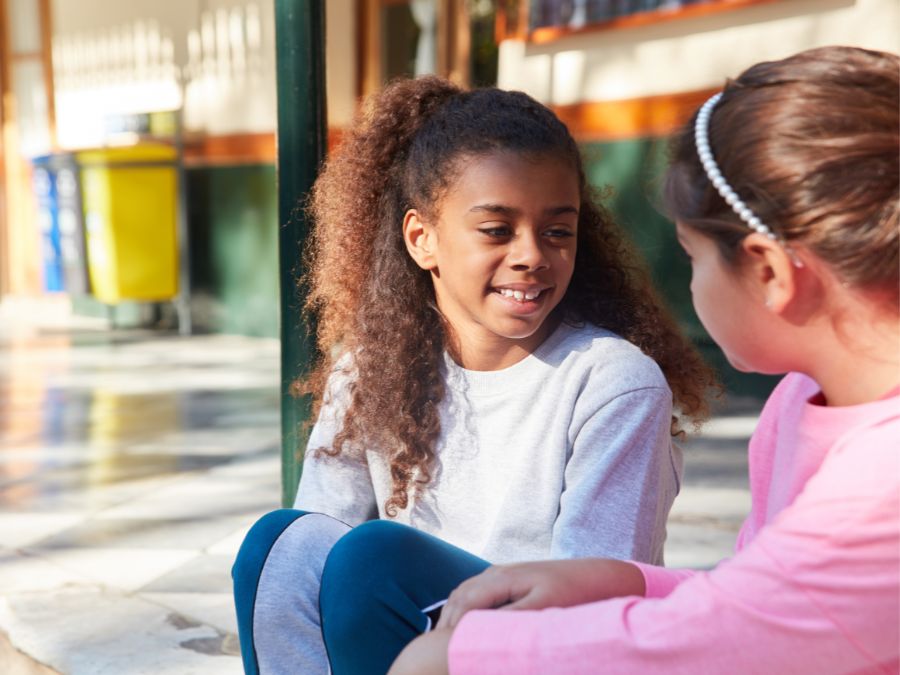 Two young girls talking together.