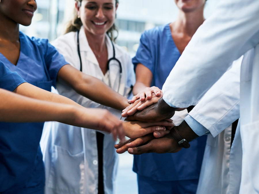 medical providers with hands in