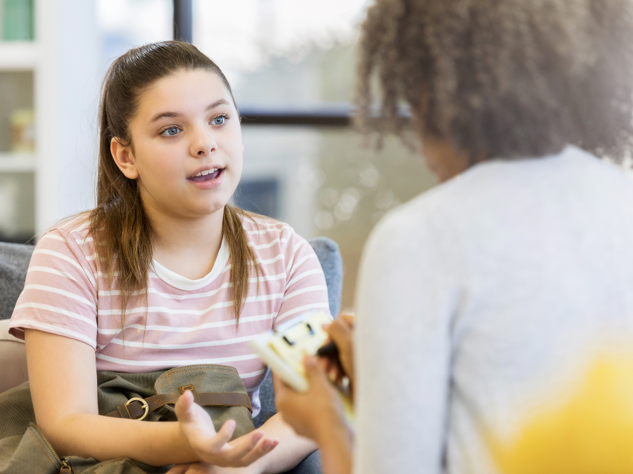 young girl speaking with a physician
