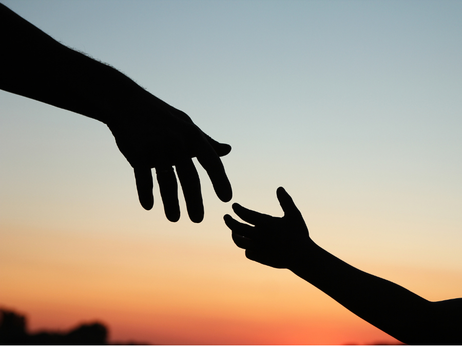 Two hands reaching out towards each other.